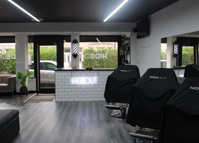 Modern interior of hideout salon in Glasgow, Scotland, GB with stylish chairs and minimalist decor.