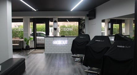 Modern interior of hideout salon in Glasgow, Scotland, GB with stylish chairs and minimalist decor.