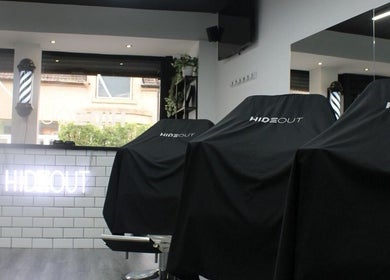 Modern interior of Hideout salon in Glasgow, Scotland, GB with chic decor and styling chairs.