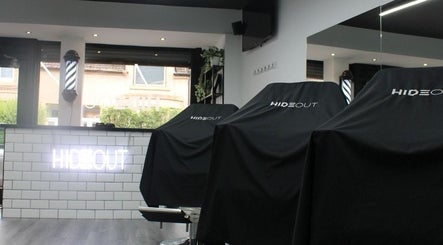 Modern interior of Hideout salon in Glasgow, Scotland, GB with chic decor and styling chairs.