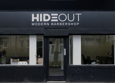 Hideout barbershop exterior in Glasgow, Scotland, GB displaying a modern black and white design.