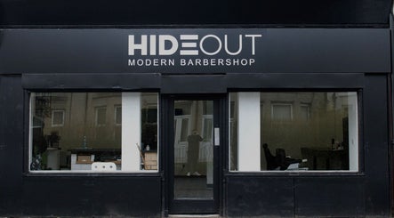 Hideout barbershop exterior in Glasgow, Scotland, GB displaying a modern black and white design.