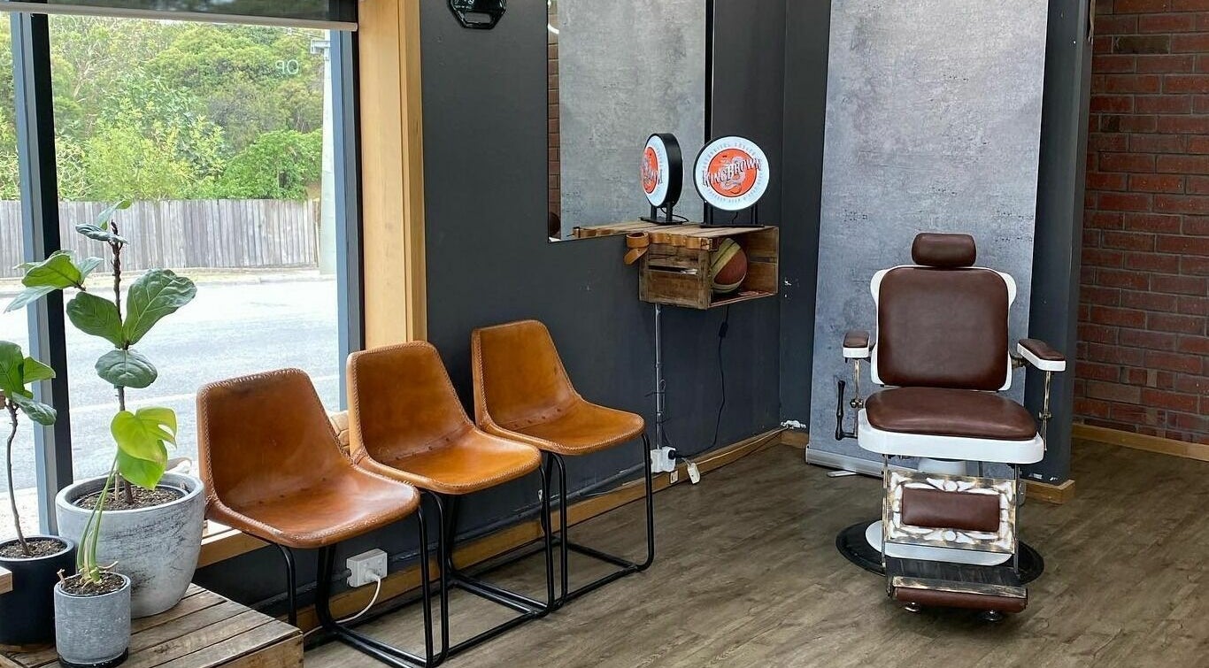 Eastside salon seating with vintage barber chair in Camberwell, VIC, AU near sunny window and greenery.