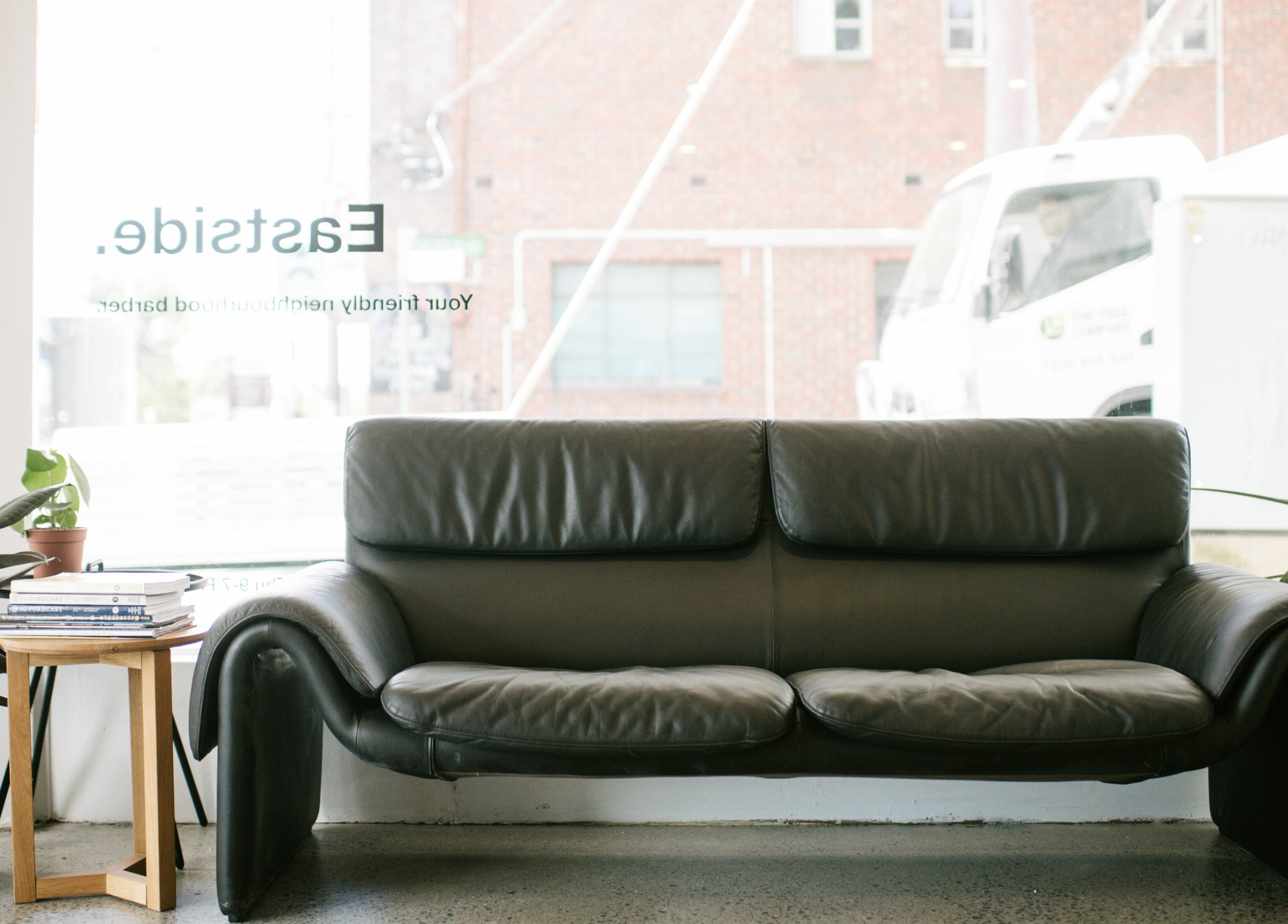 Cozy leather sofa by a window in Eastside, Camberwell, VIC, AU.
