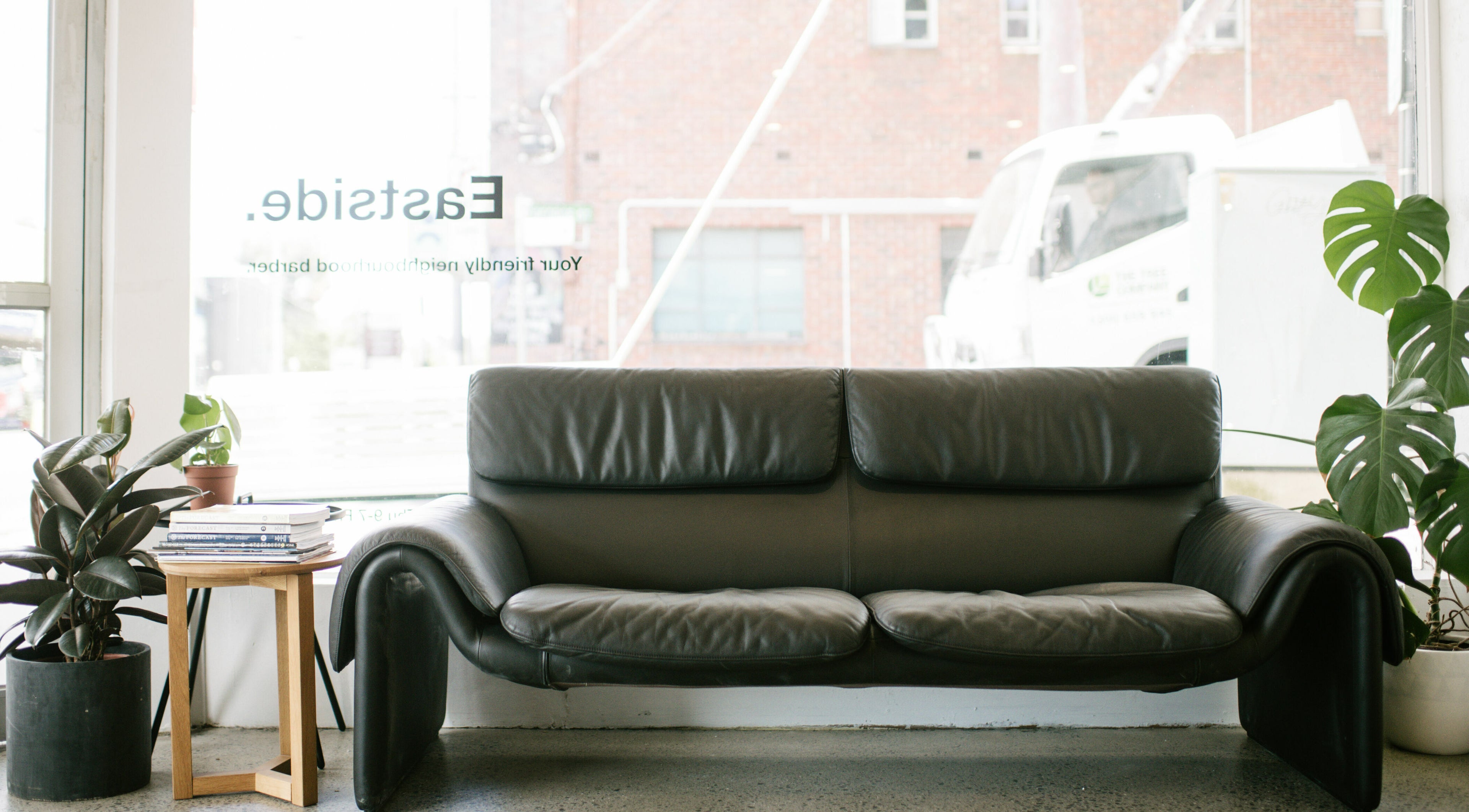 Cozy leather sofa by a window in Eastside, Camberwell, VIC, AU.