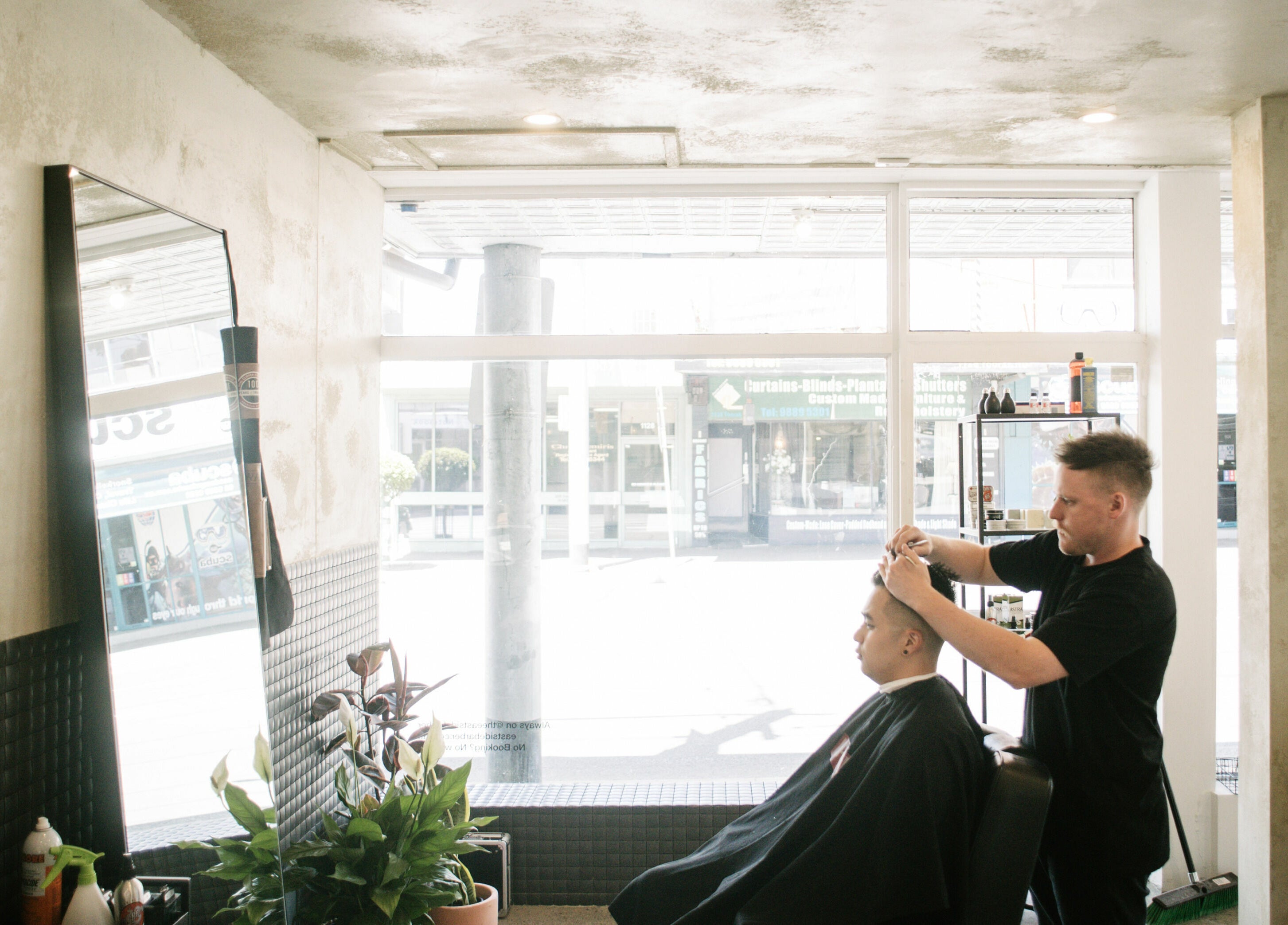 Hair styling session at Eastside salon, Camberwell, VIC, AU, with natural light and modern decor.