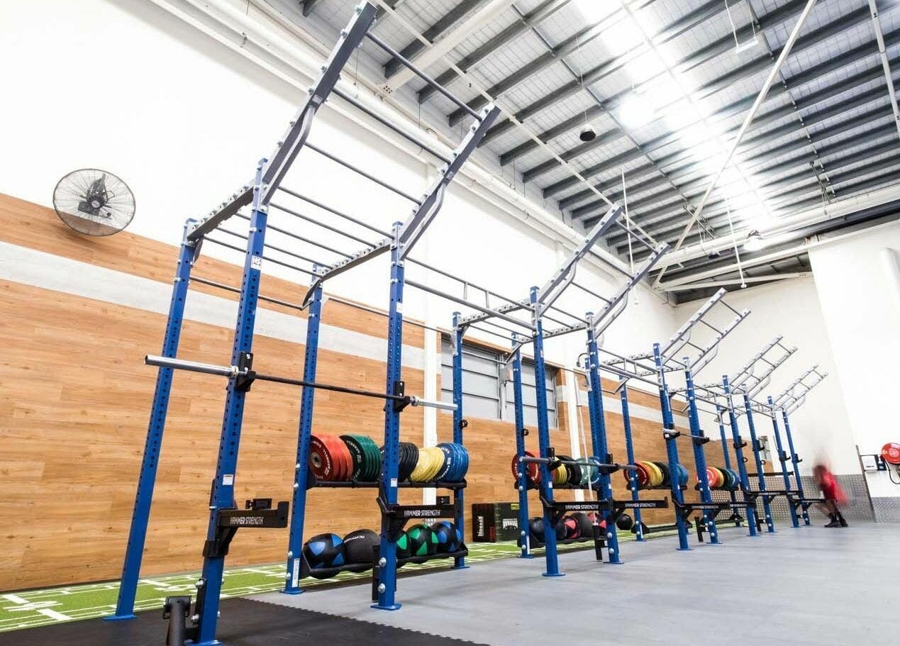Modern gym facility at EMF Performance Centre | Coomera, Upper Coomera, Queensland, AU with weight racks.
