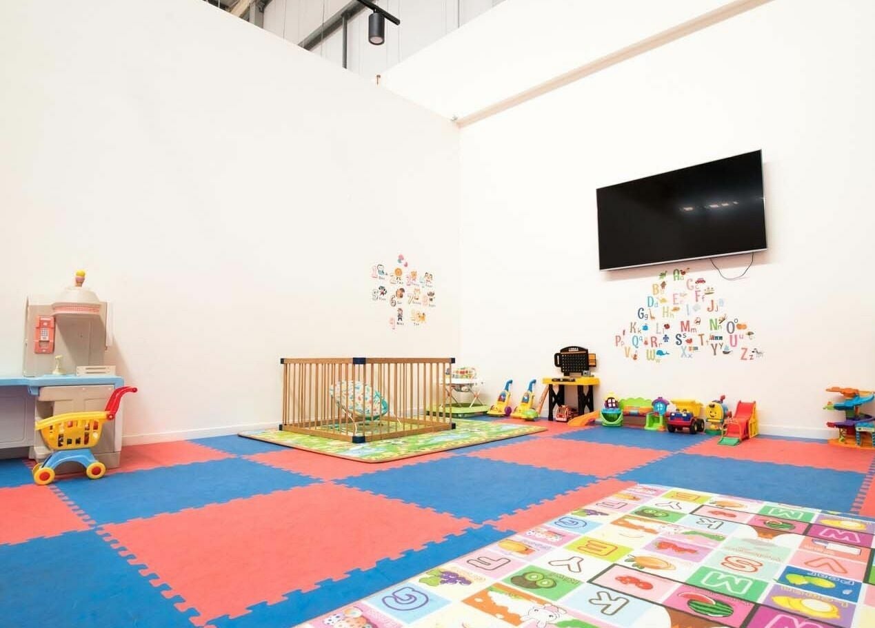 Colorful kids' play area at EMF Performance Centre | Coomera in Upper Coomera, Queensland, AU with toys and mats.