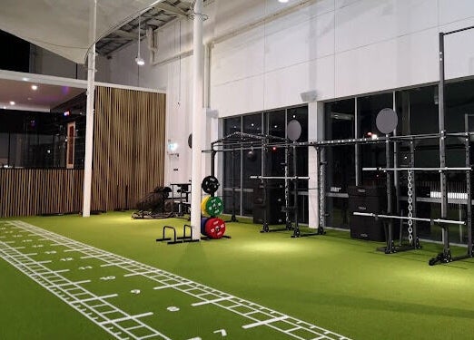 Modern gym equipment on green turf at EMF Performance and Recovery Centre | Nerang, Highland Park, Queensland, AU.