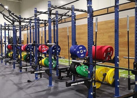 Modern gym area at EMF Performance and Recovery Centre | Nerang in Highland Park, Queensland, AU with colorful weights.