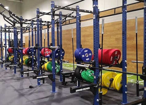 Modern gym area at EMF Performance and Recovery Centre | Nerang in Highland Park, Queensland, AU with colorful weights.