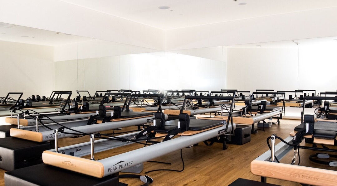 Pilates reformers at EMF Performance Centre | North Lakes, Queensland, AU in a serene studio setting.