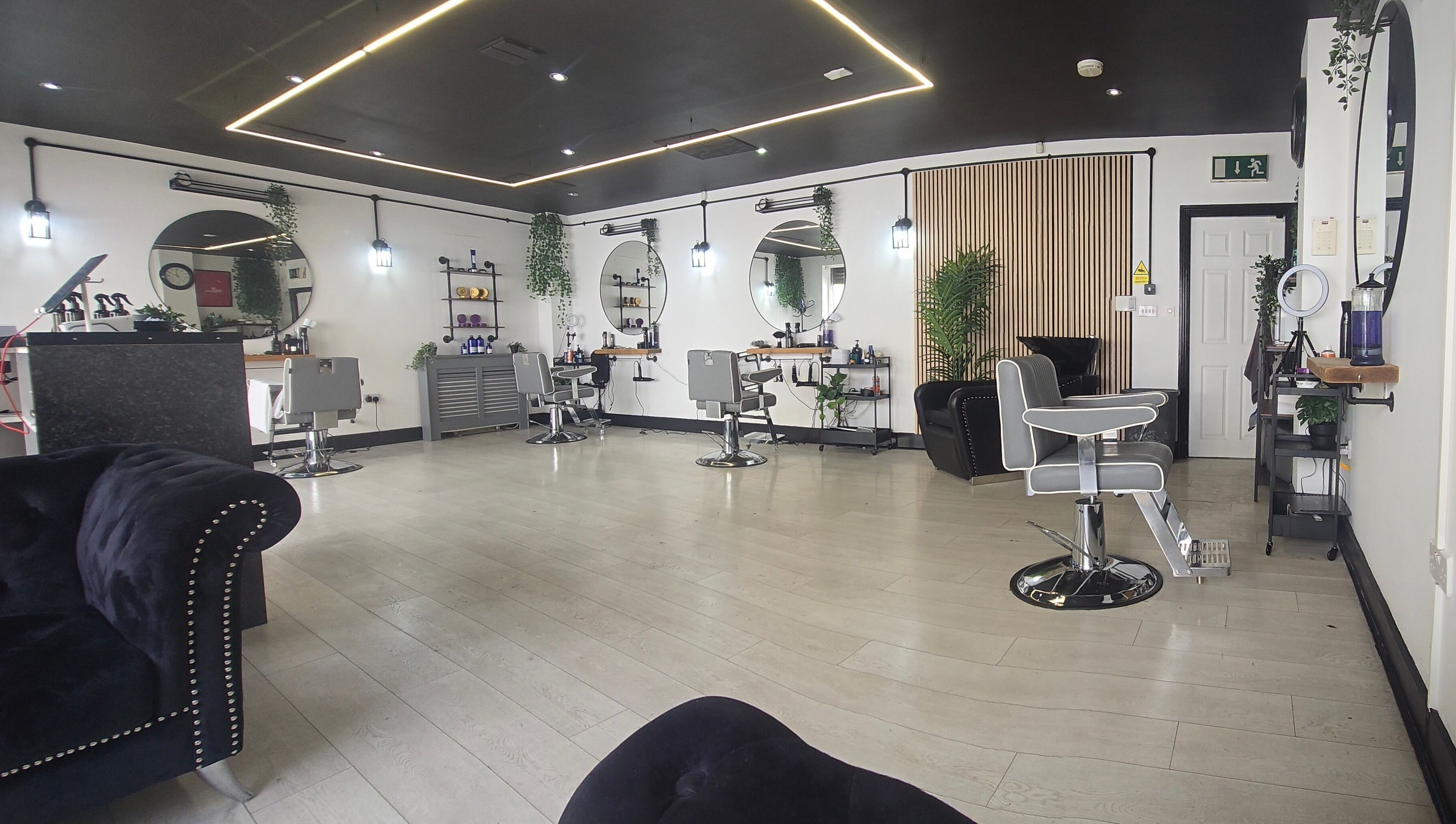 Chic interior of Nobleman's Barbershop Newbridge, Newbridge, County Kildare, IE featuring sleek styling chairs.