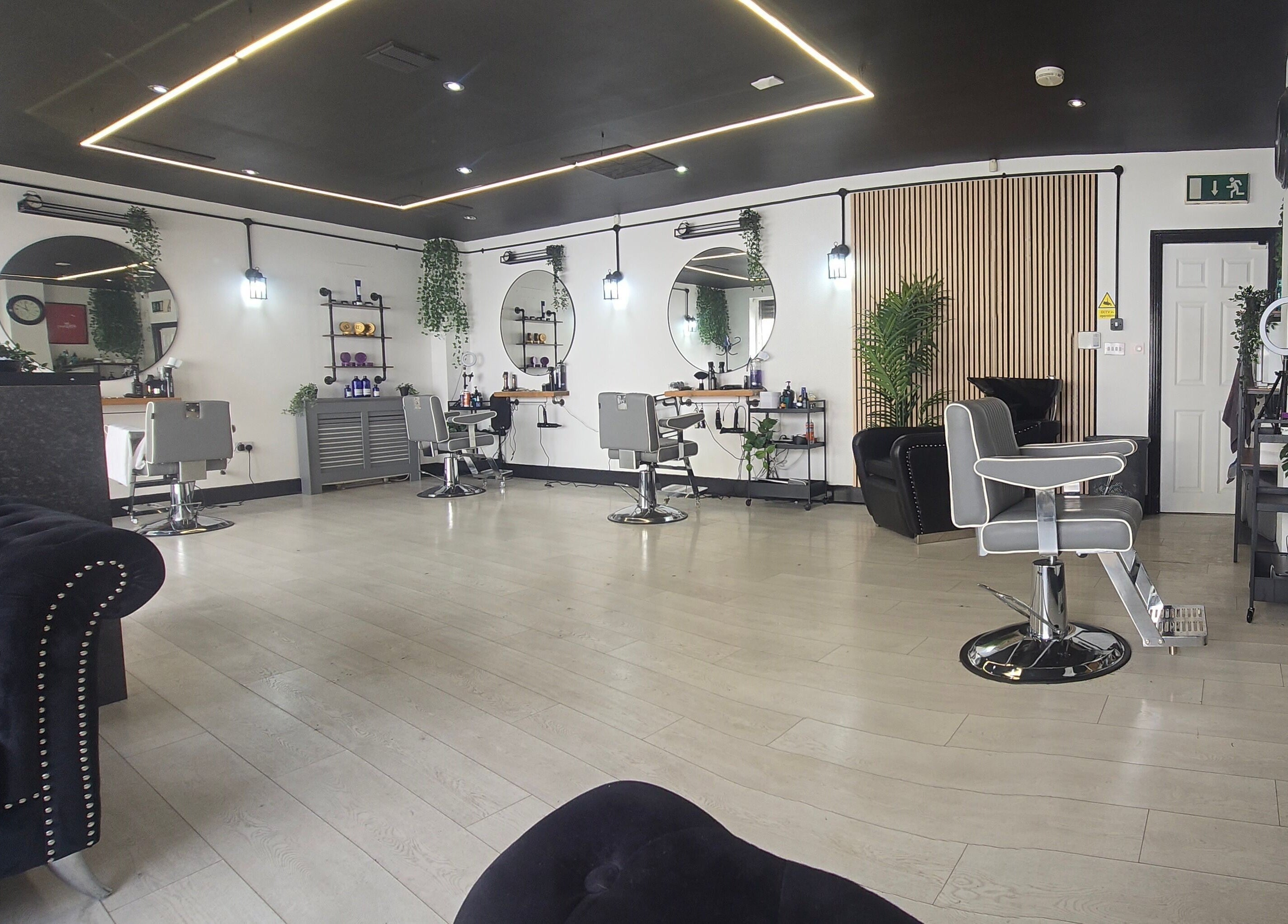 Chic interior of Nobleman's Barbershop Newbridge, Newbridge, County Kildare, IE featuring sleek styling chairs.