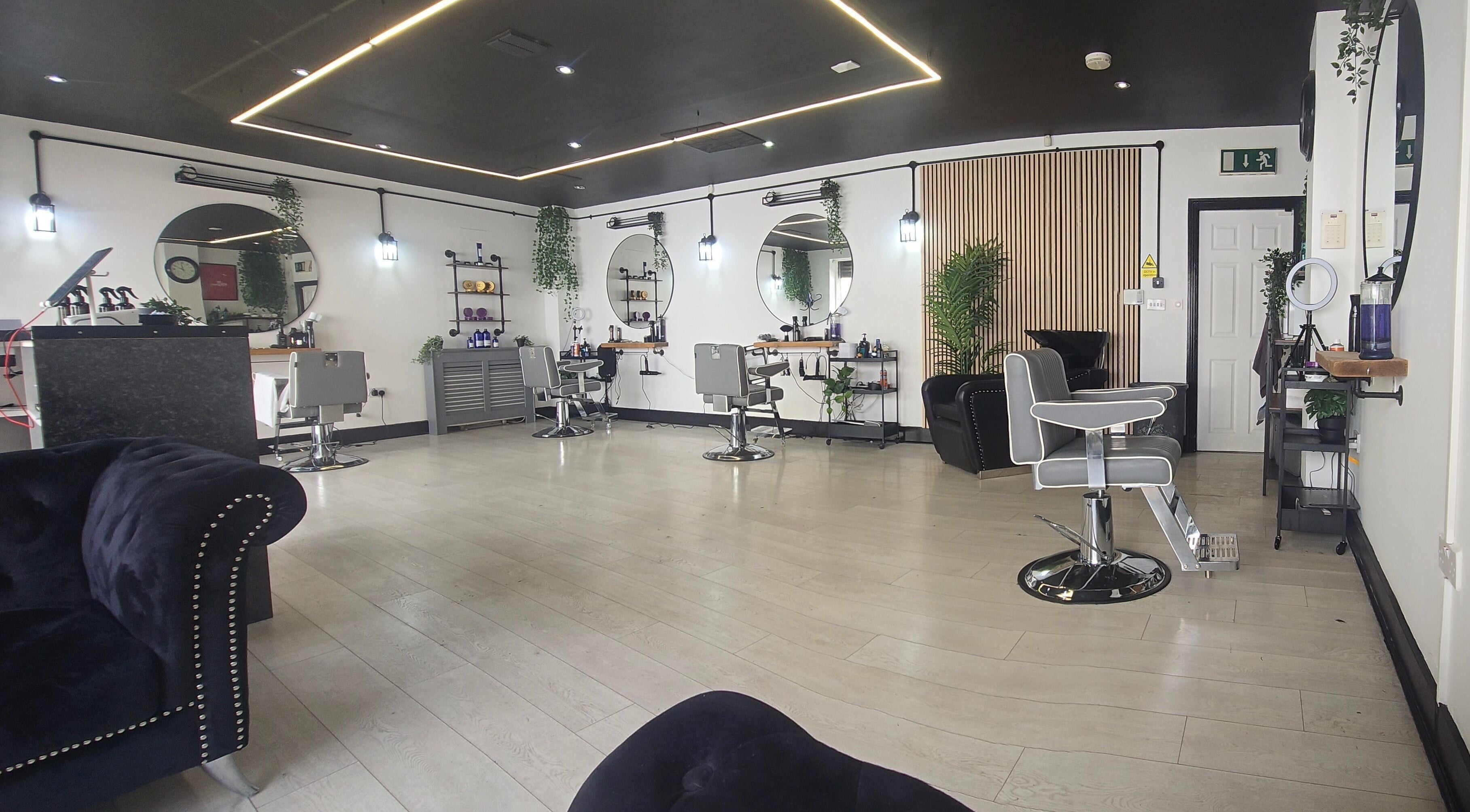 Chic interior of Nobleman's Barbershop Newbridge, Newbridge, County Kildare, IE featuring sleek styling chairs.