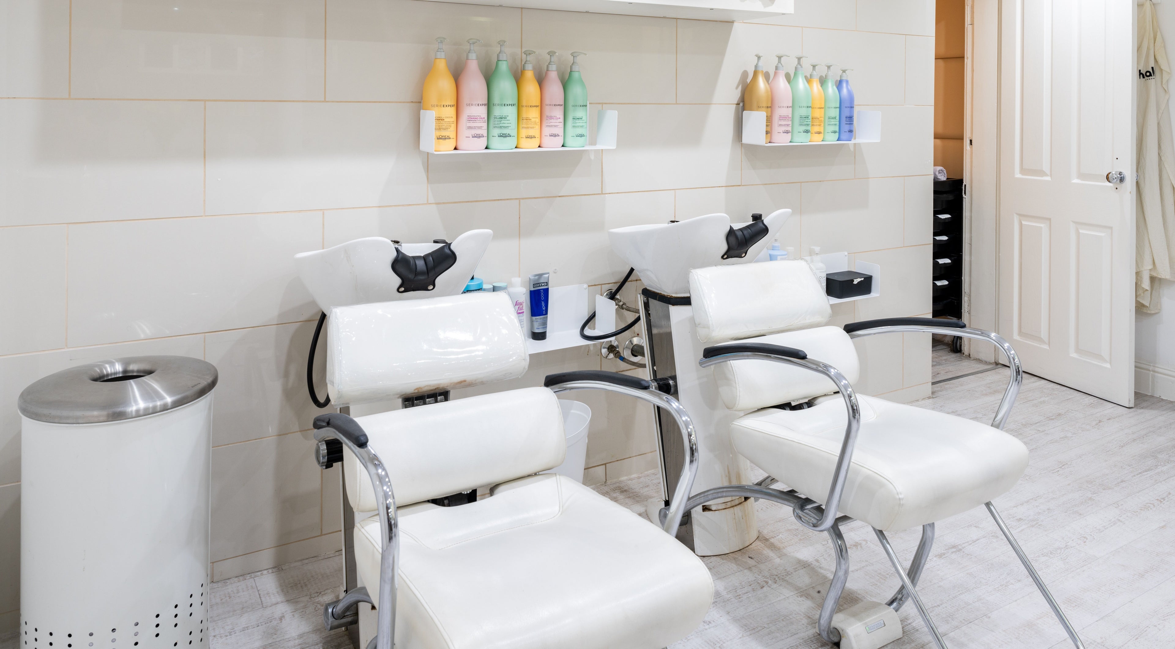 Modern wash stations at Halo London Hair Salon, London, England, GB, offering a stylish and clean experience.
