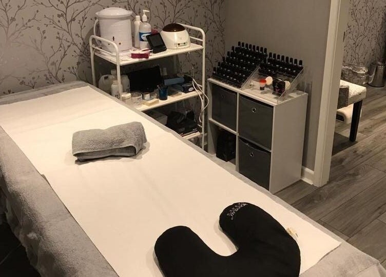 Calming treatment room at Jodie's Beauty & Aesthetics Lounge, Lancaster, England, GB, featuring a massage bed.