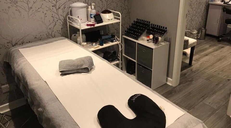 Calming treatment room at Jodie's Beauty & Aesthetics Lounge, Lancaster, England, GB, featuring a massage bed.