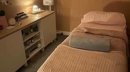 Relaxing massage room at Applewood Wellness, Upton, England, GB. Cozy spa ambiance with warm lighting.
