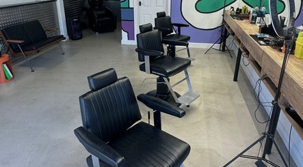 Modern barber chairs at Blades Barbers, Hereford, England, GB with a chic interior setting.