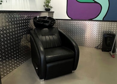Modern hair washing chair at Blades Barbers, Hereford, England, GB with sleek decor and comfortable design.