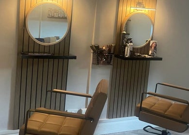 Modern salon setup at Lebeau, Bridgnorth, England, GB with stylish mirrors and chairs.