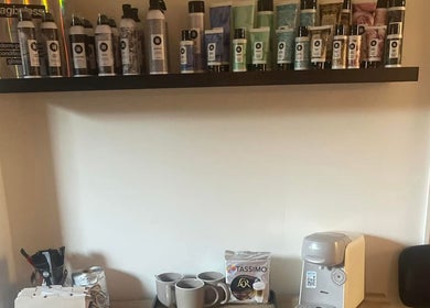 Lebeau beauty products display on shelf in Bridgnorth, England, GB. Coffee station below for client comfort.