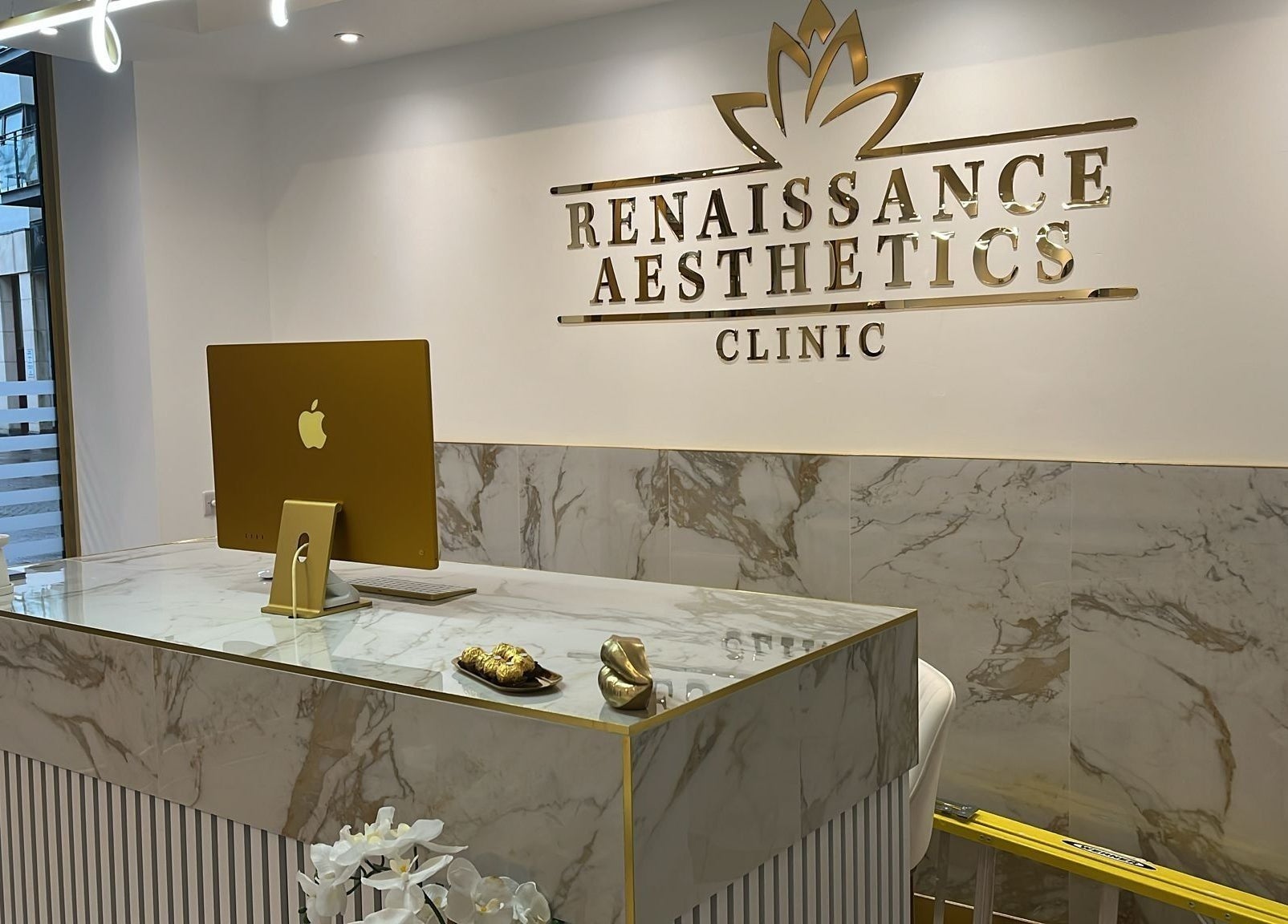 Reception desk at Renaissance Aesthetics, Sligo, County Sligo, IE, showcasing modern decor and branding.