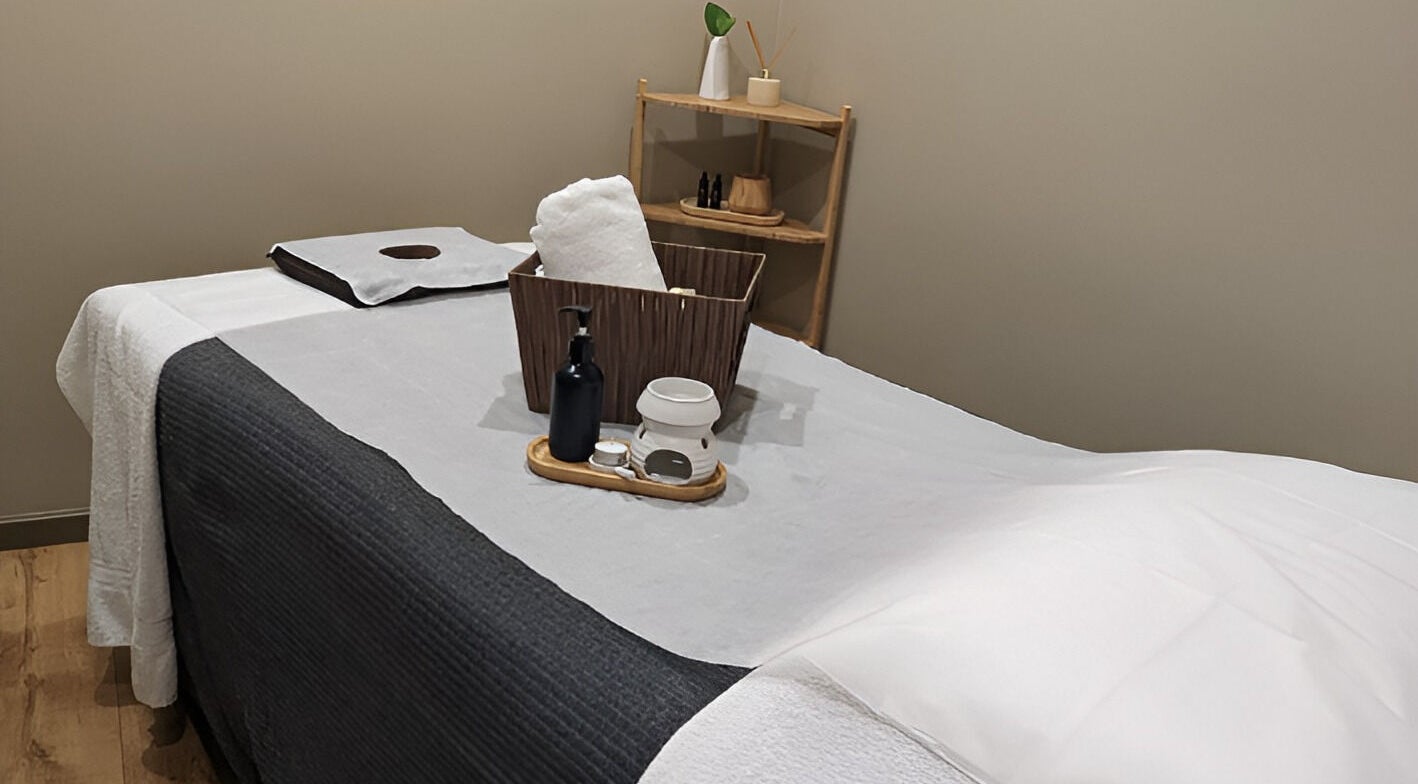 Serenity Cammeray Lux Spa massage room with oils and towels, Cammeray, New South Wales, AU.