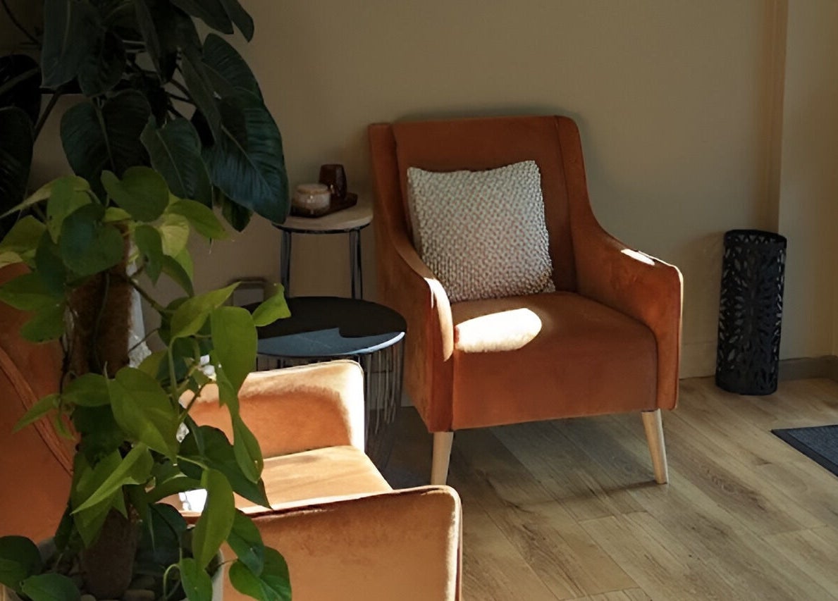 Inviting seating area at Serenity Cammeray Lux Spa, Cammeray, New South Wales, AU with plush chairs and leafy plant.