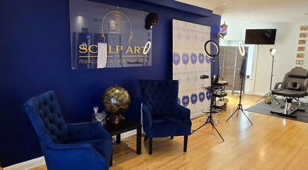 Elegant interior of Scalp Art Clinic in South Woodham Ferrers, England, featuring blue chairs and modern decor.