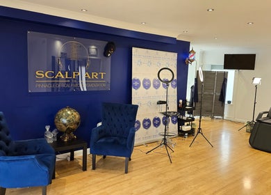 Scalp Art Clinic interior in South Woodham Ferrers, England, with blue chairs and modern lighting.