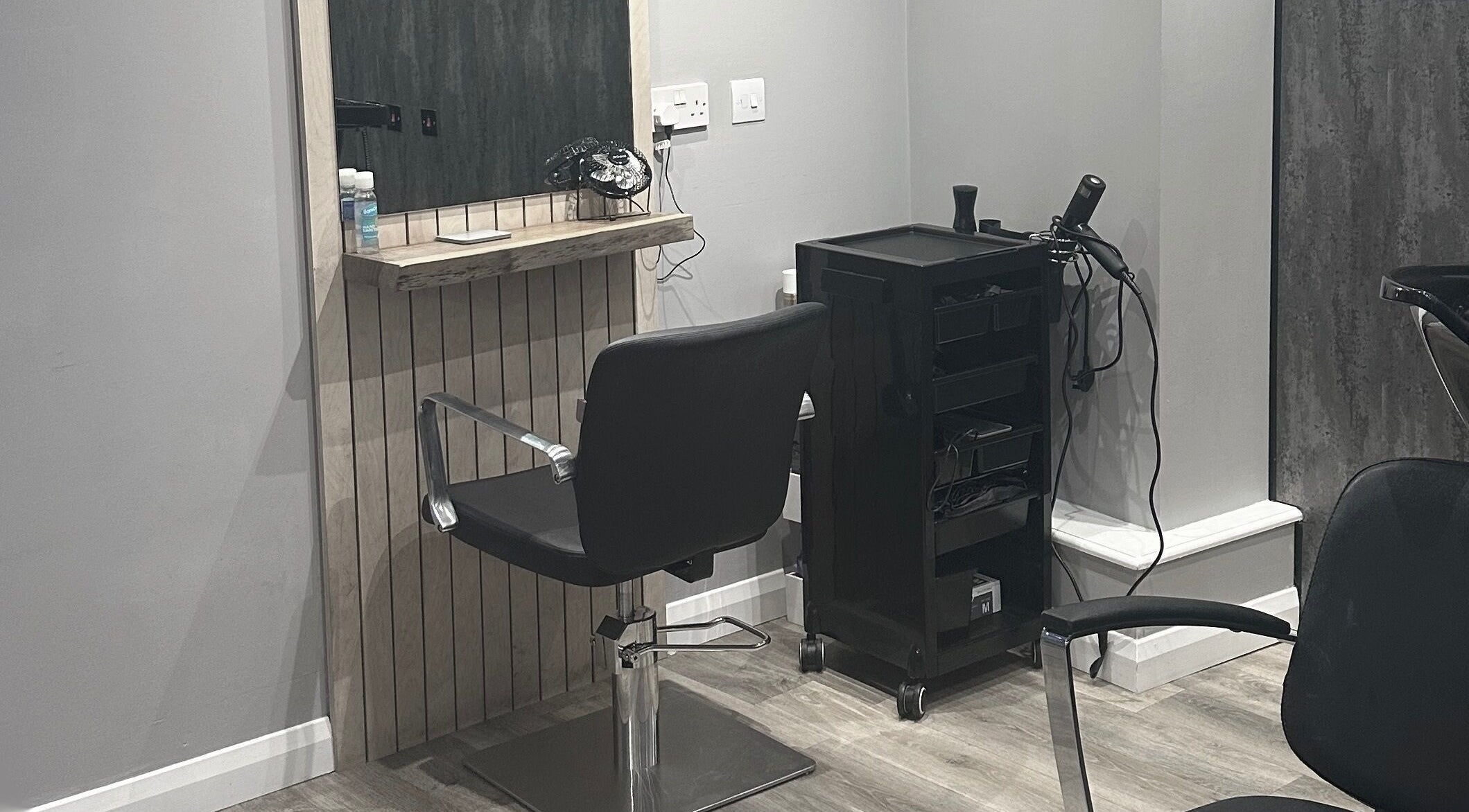 Modern salon chair at Hair by Almond, Bodmin, England, GB, providing sleek haircut services.