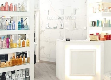 Interior of Leonards Hair, Tas-Sliema, MT, showcasing elegant product shelves with beauty items.