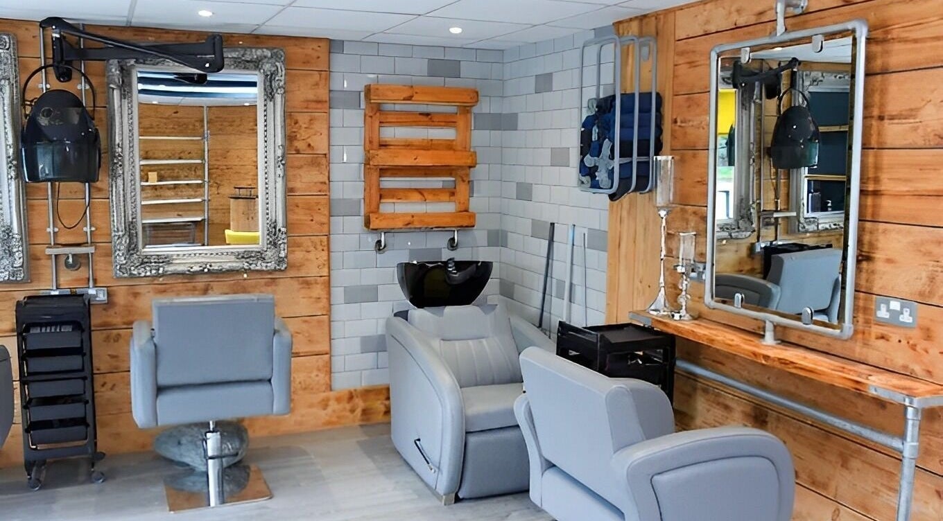 Modern salon interior at Adore Nails and Beauty, Truro, England, GB, featuring stylish chairs and mirrors.