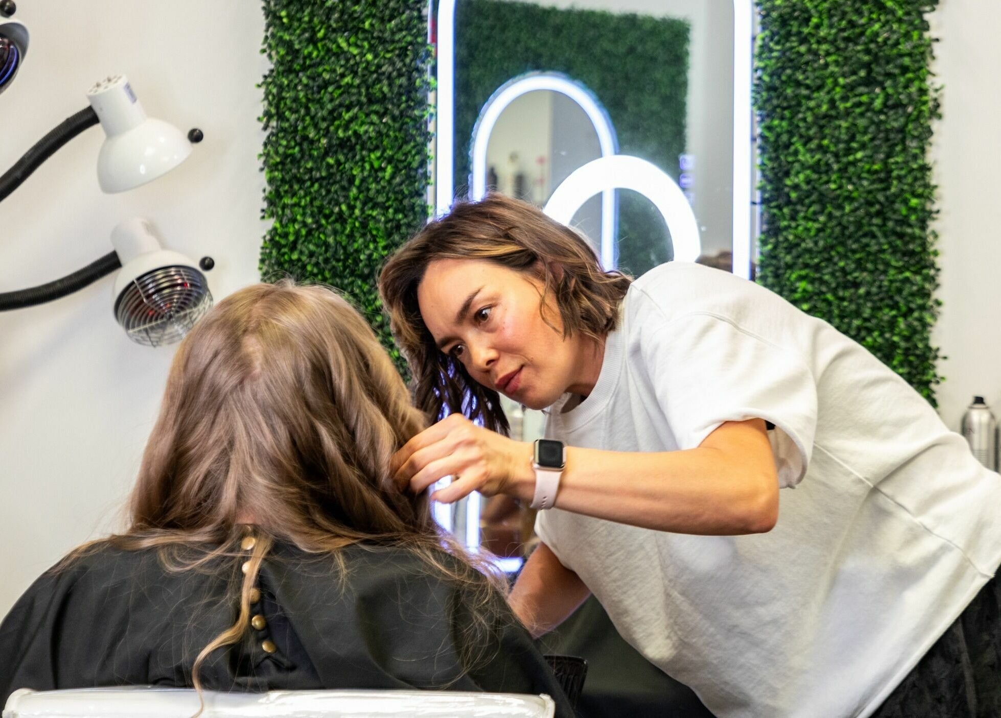 Hair stylist working on client's hair at Viva Beauty Bar Via Maks Salon, Cumming, Georgia, US.
