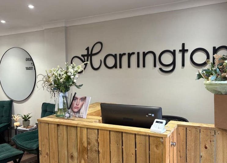 Reception area at Harringtons Devizes, Devizes, GB showcasing stylish seating and floral decor.