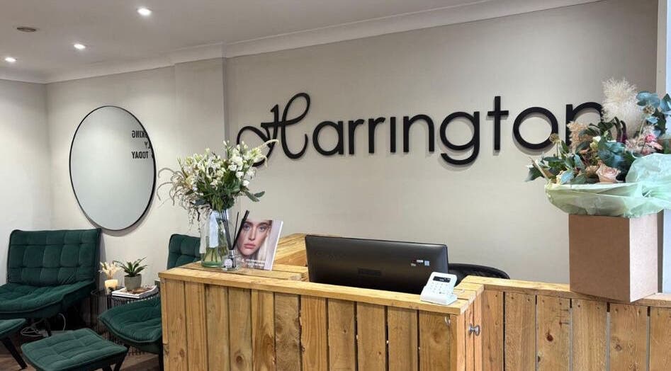 Reception area at Harringtons Devizes, Devizes, GB showcasing stylish seating and floral decor.