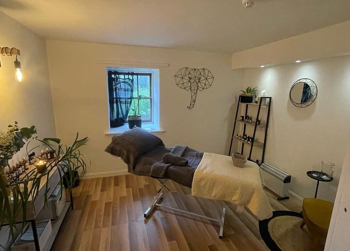 Tranquil massage room at The Wellness Lounge with Oils in Bloom, East Lothian, Scotland, GB. Soft lighting and decor.
