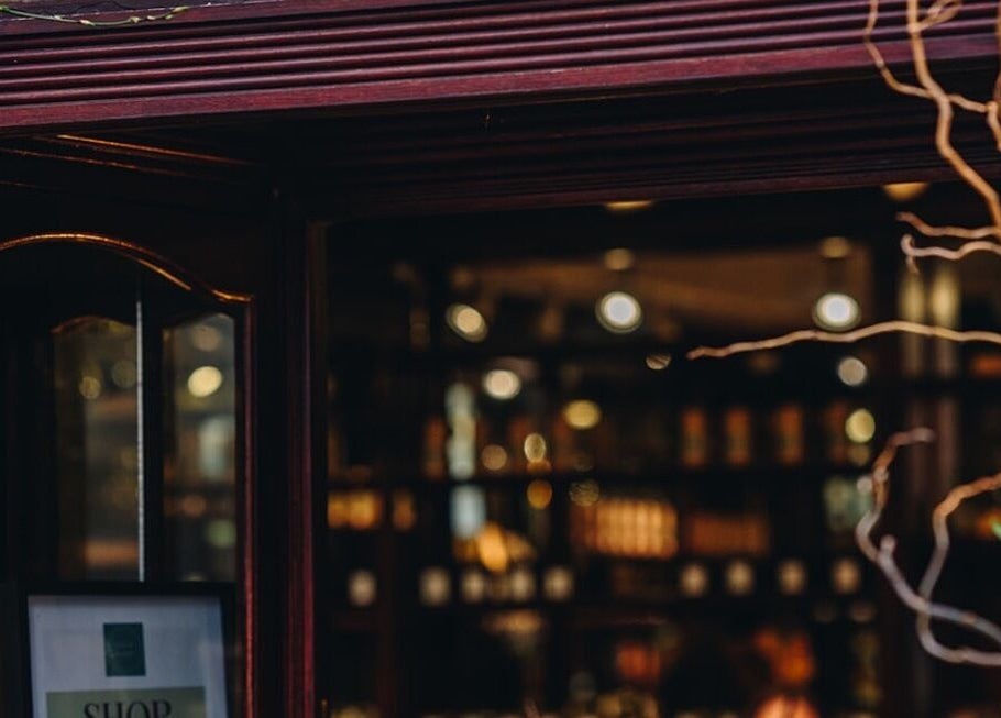 Inviting entrance of The Wellness Lounge with Oils in Bloom, East Lothian, Scotland, GB, warmly lit interior.