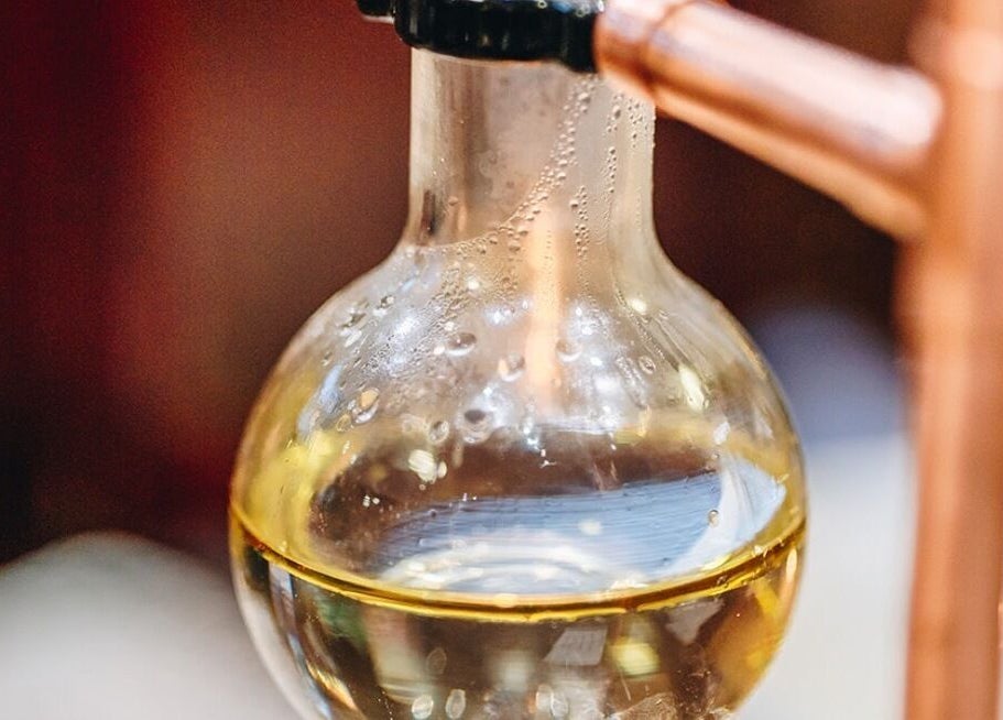 Aromatic oils in a glass decanter at The Wellness Lounge with Oils in Bloom, East Lothian, Scotland, GB.