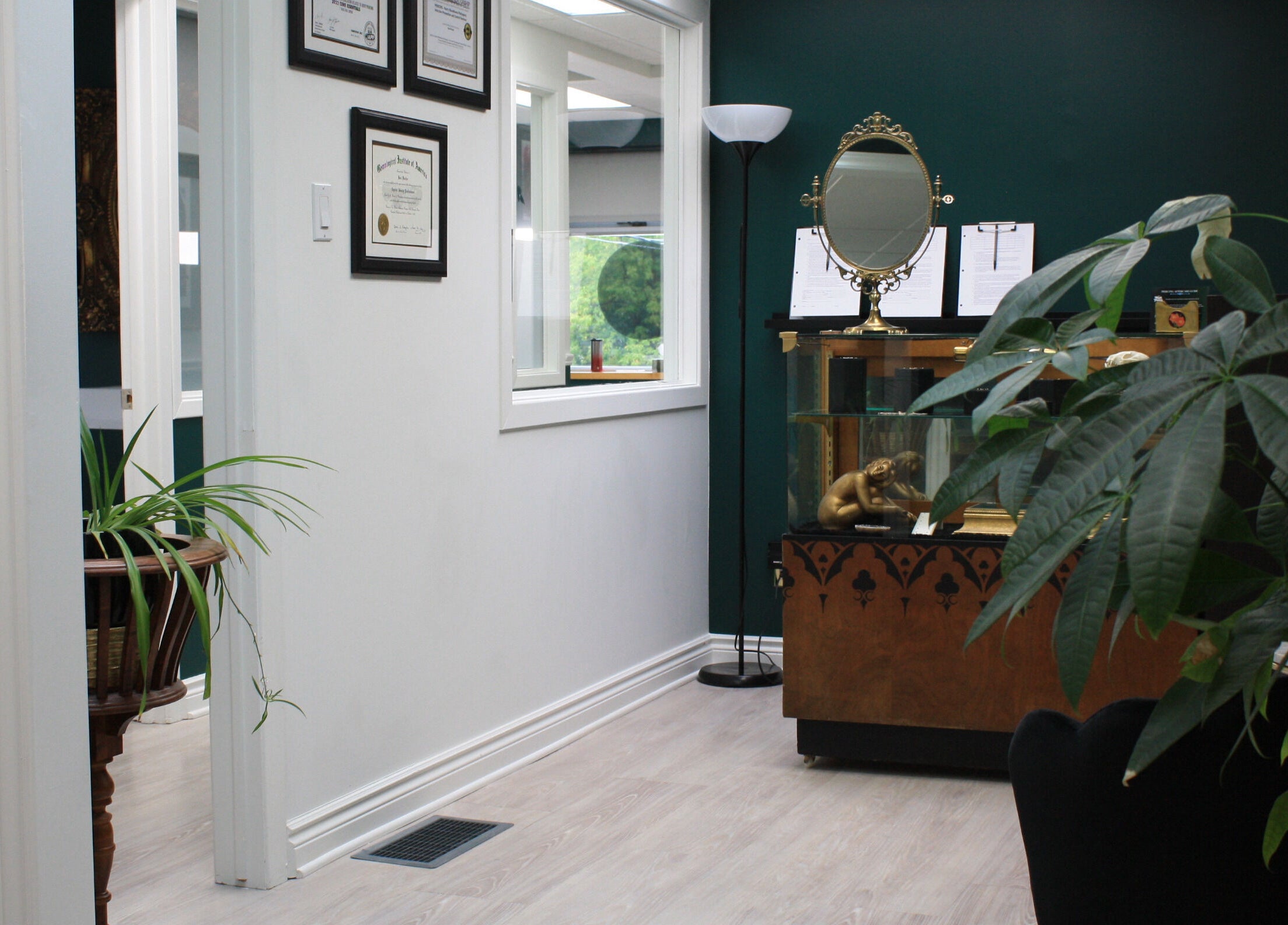 Entrance of Relic Piercing And Tattoo in Ottawa, Ontario, CA showcasing decor and framed certificates.