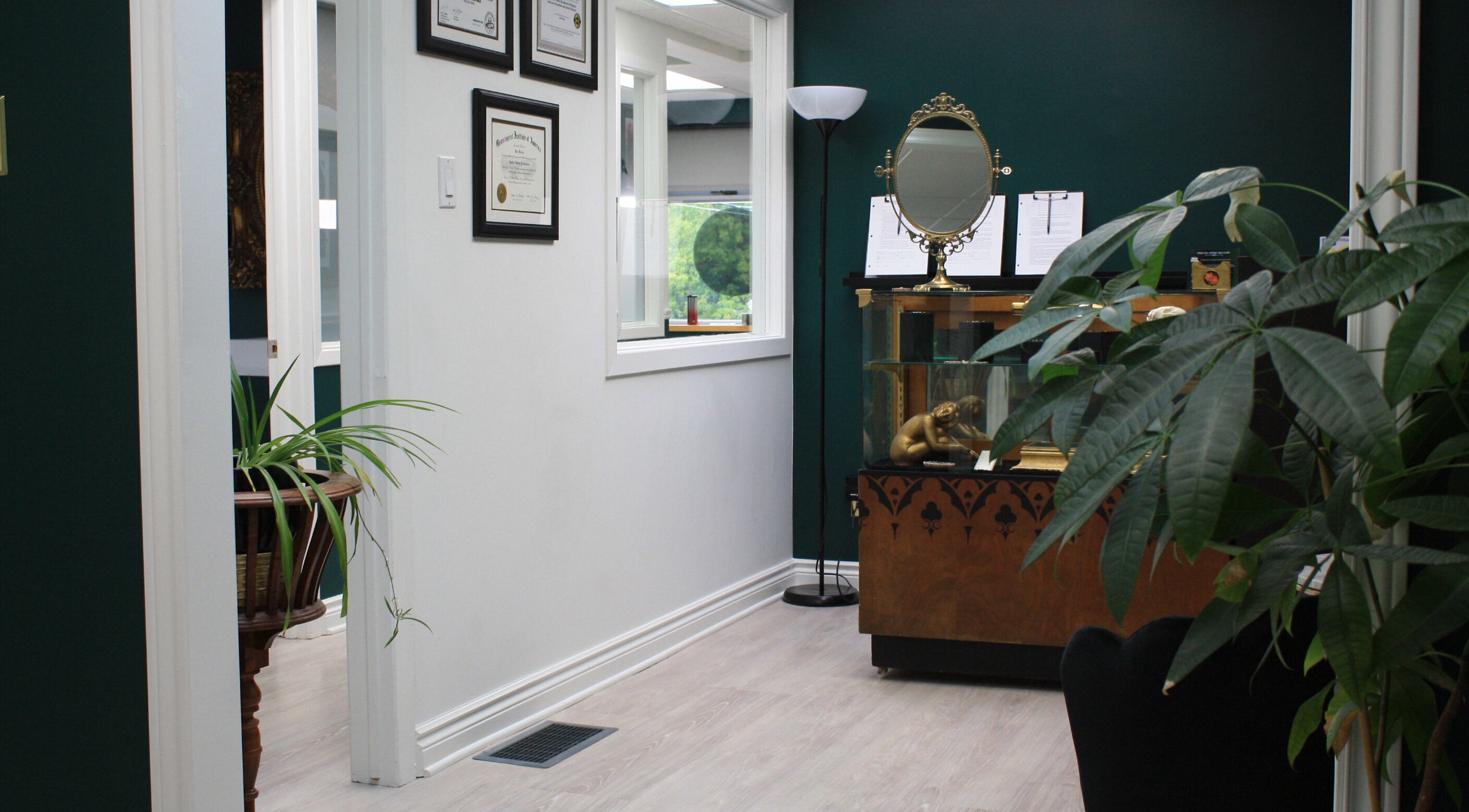 Entrance of Relic Piercing And Tattoo in Ottawa, Ontario, CA showcasing decor and framed certificates.