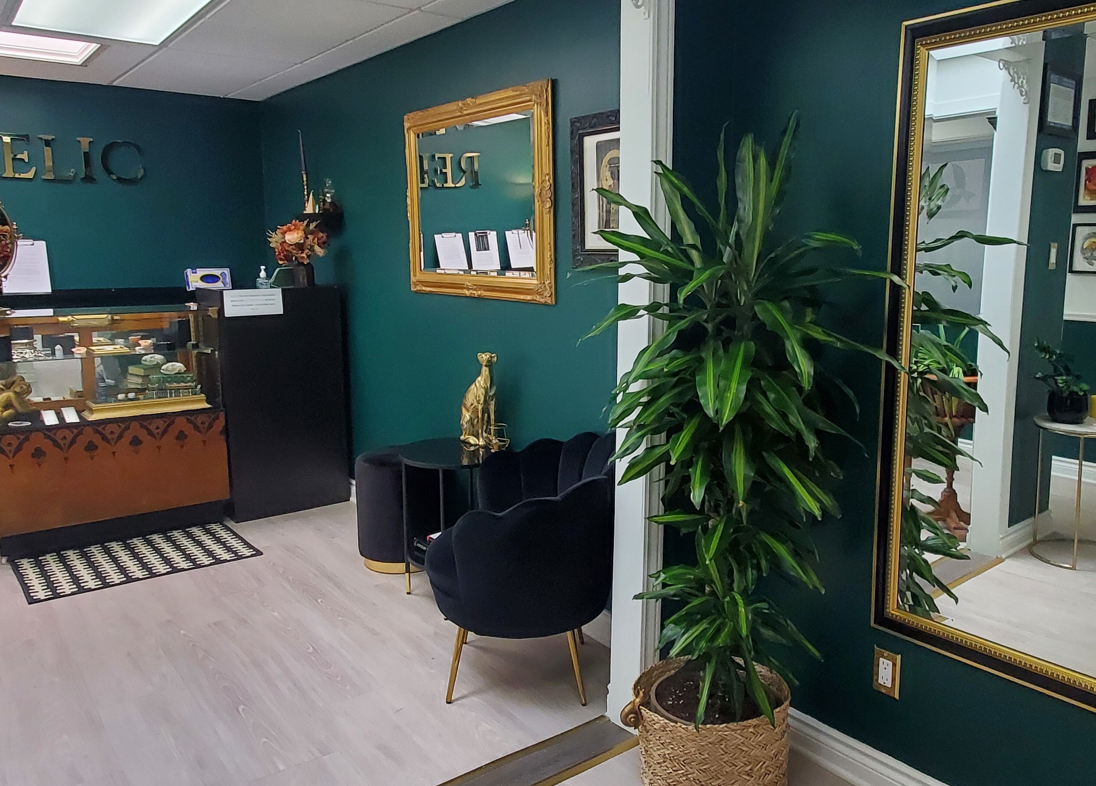 Chic interior of Relic Piercing And Tattoo in Ottawa, Ontario, CA, featuring green walls and elegant decor.