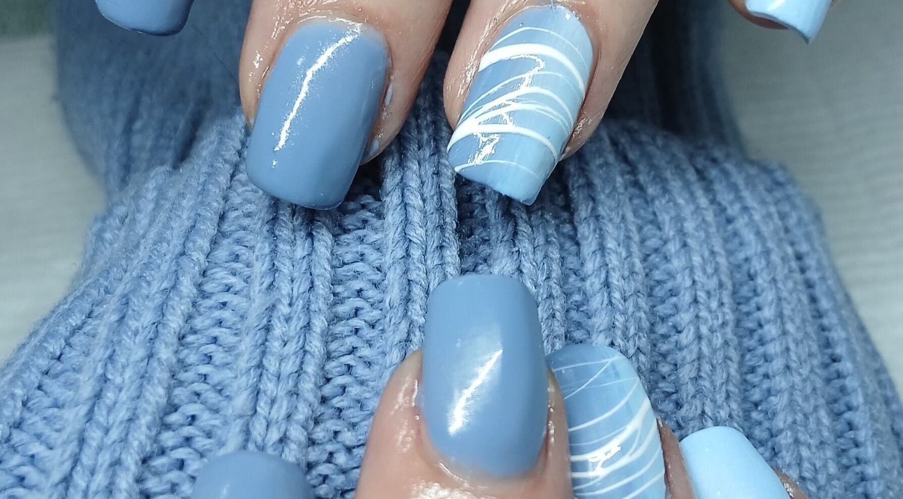 Elegant blue nails with white designs by Nails by Karen, Cape Town, Western Cape, ZA.