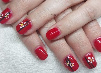 Elegant red nails with floral art at Nails by Karen, Cape Town, Western Cape, ZA.