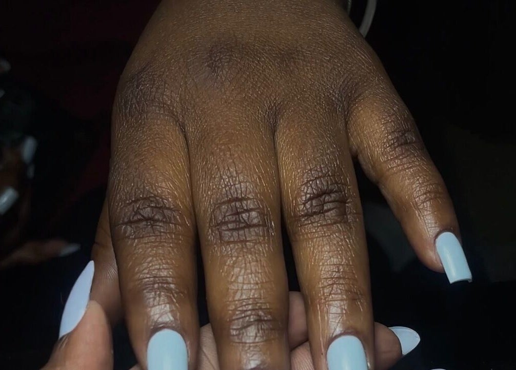 Close-up of manicured nails with pastel polish at GelJunkiess & Co., Portmore, JM.