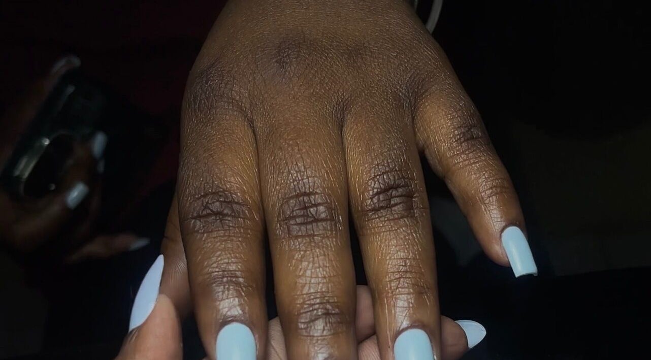 Close-up of manicured nails with pastel polish at GelJunkiess & Co., Portmore, JM.