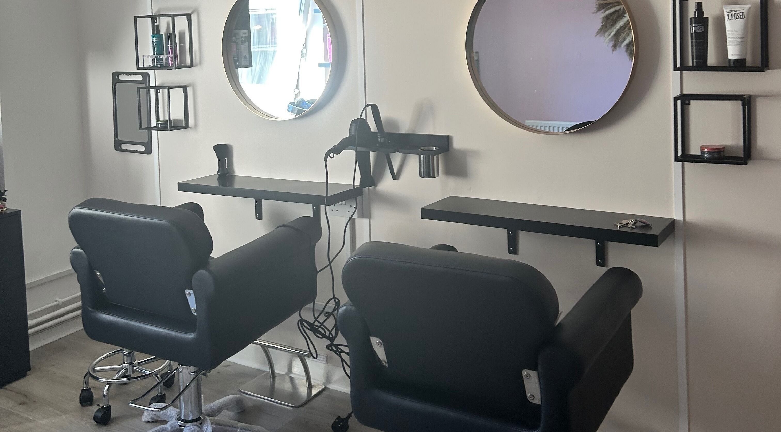 Modern salon stations at Locks of Love Hair by Claire, Paisley, Scotland, GB. Sleek design for premium hair care.