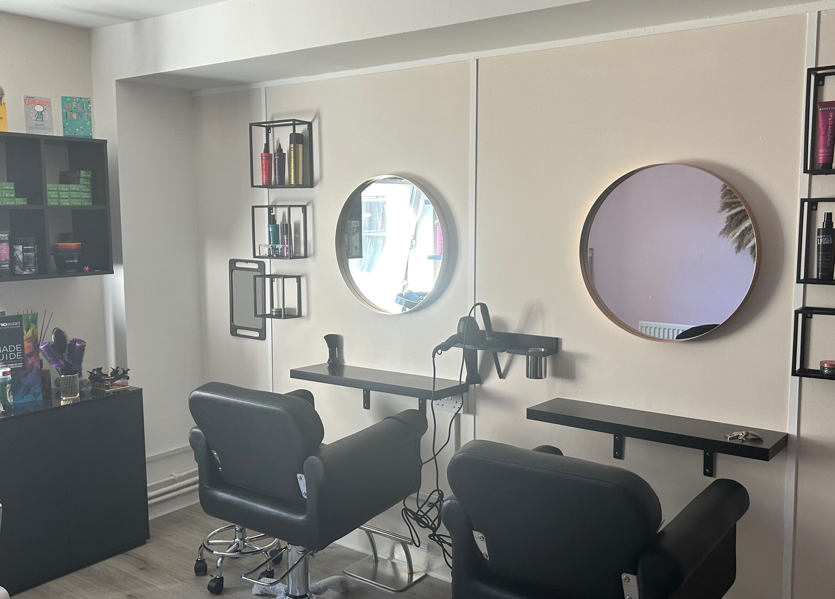 Cozy salon interior at Locks of Love Hair by Claire, Paisley, Scotland, GB, showcasing chic styling chairs and mirrors.